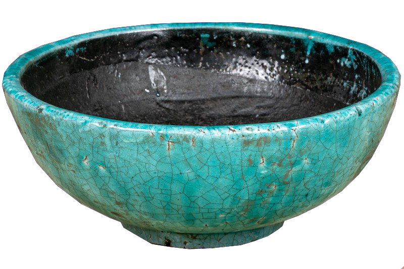 a pottery bowl in a crackle glaze finish in vibrant turquoise color.